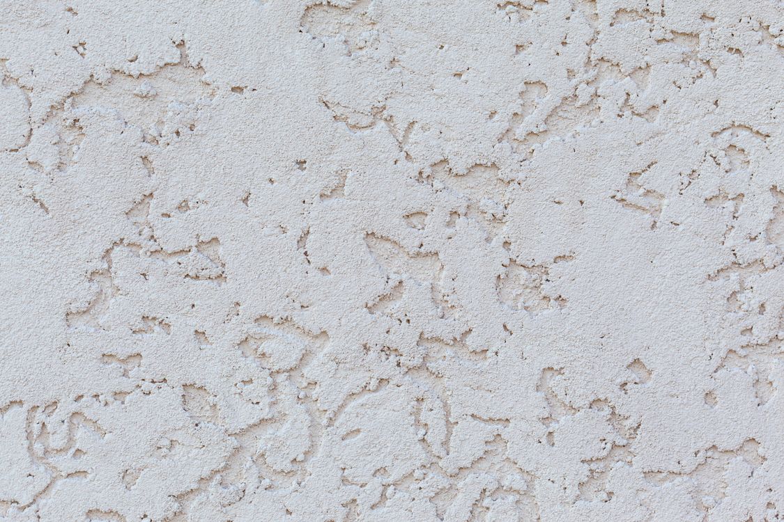 Close-up van een gestucte witte pleisterwand